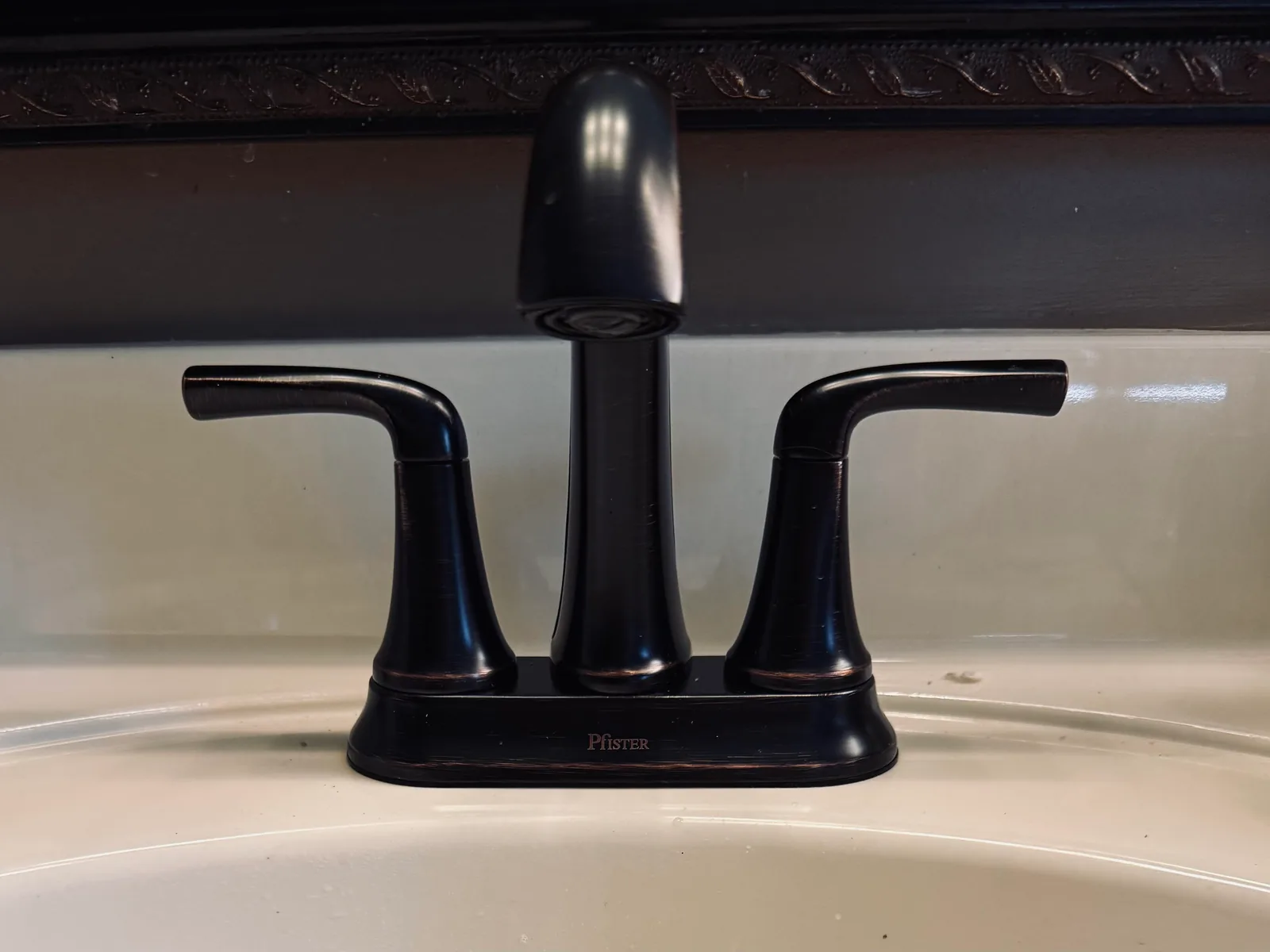 Dark bronze two handle bathroom faucet on a sink, faucet repair