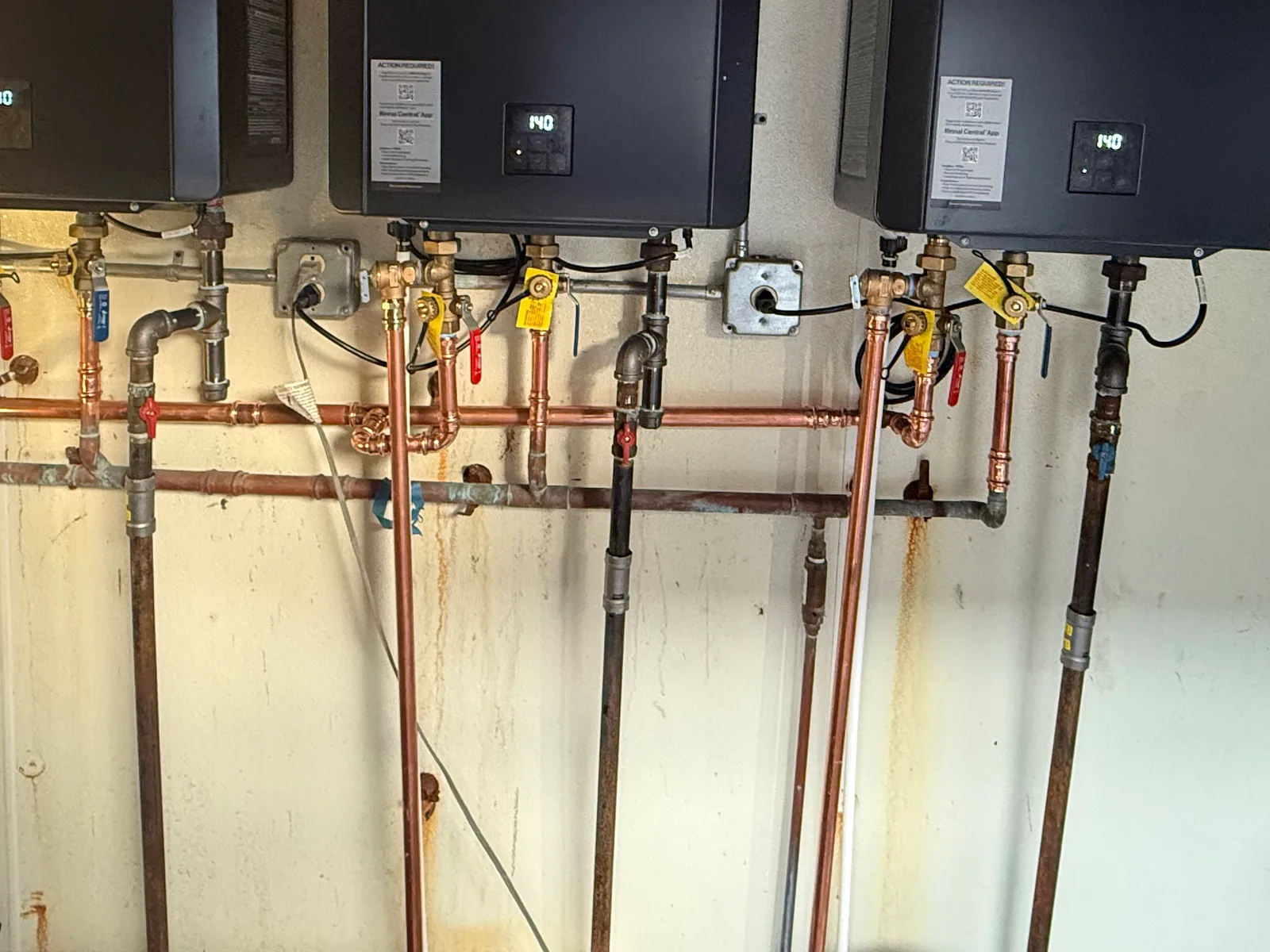 Black iron gas lines and shutoff valves feeding tankless water heaters, gas line installation