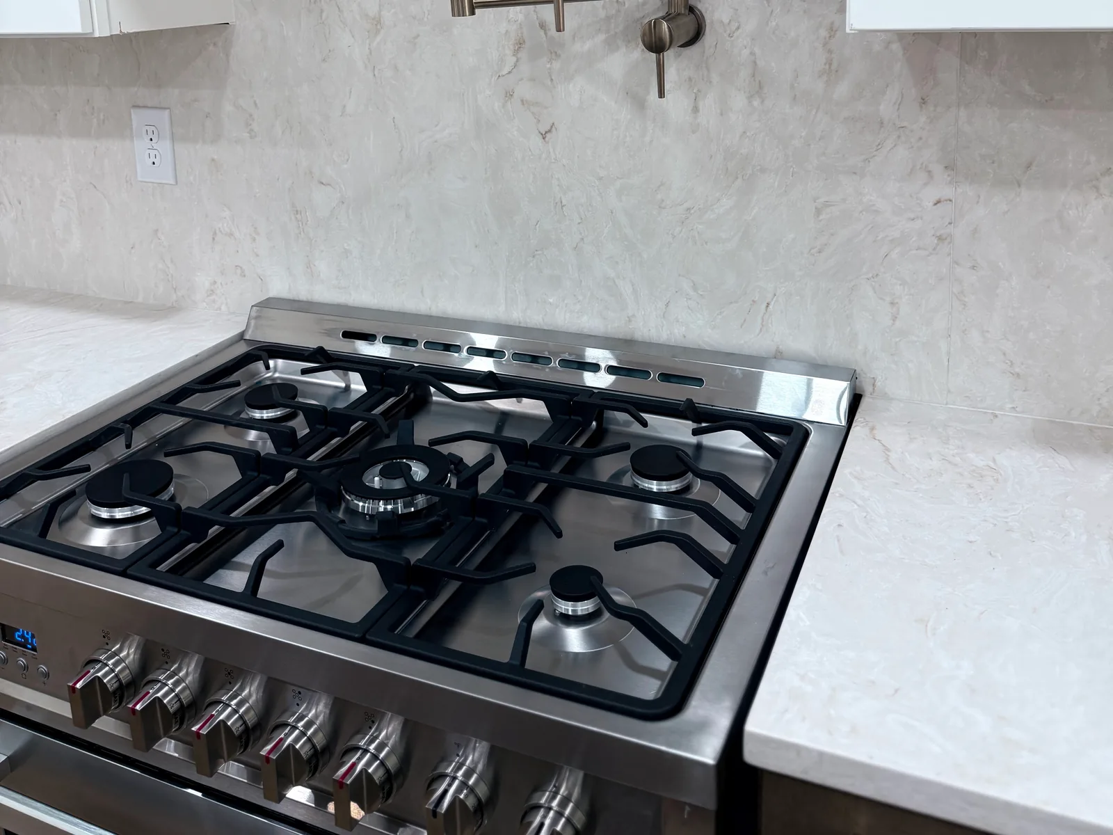 Gas range below a wall mounted pot filler, gas line installation