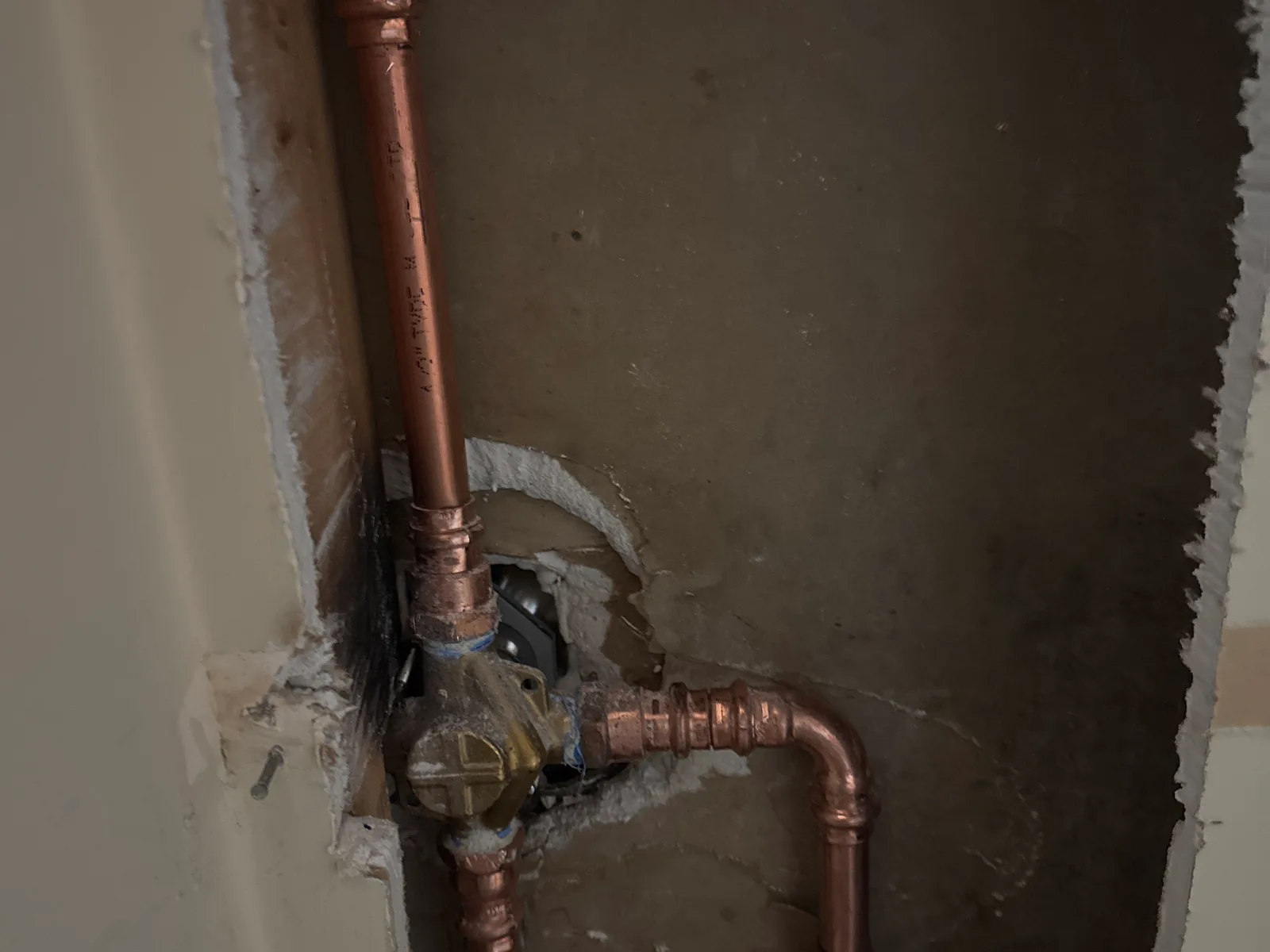 Shower valve and new copper pipes behind an opened wall, leak detection and repair