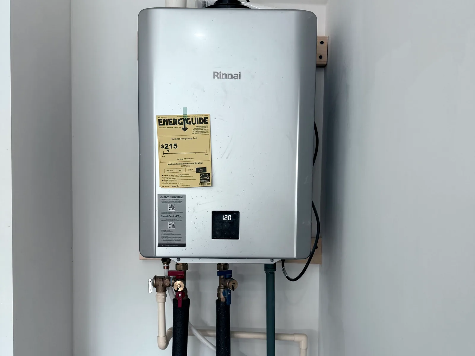 Tankless water heater mounted on a wall with new piping, tankless water heater installation