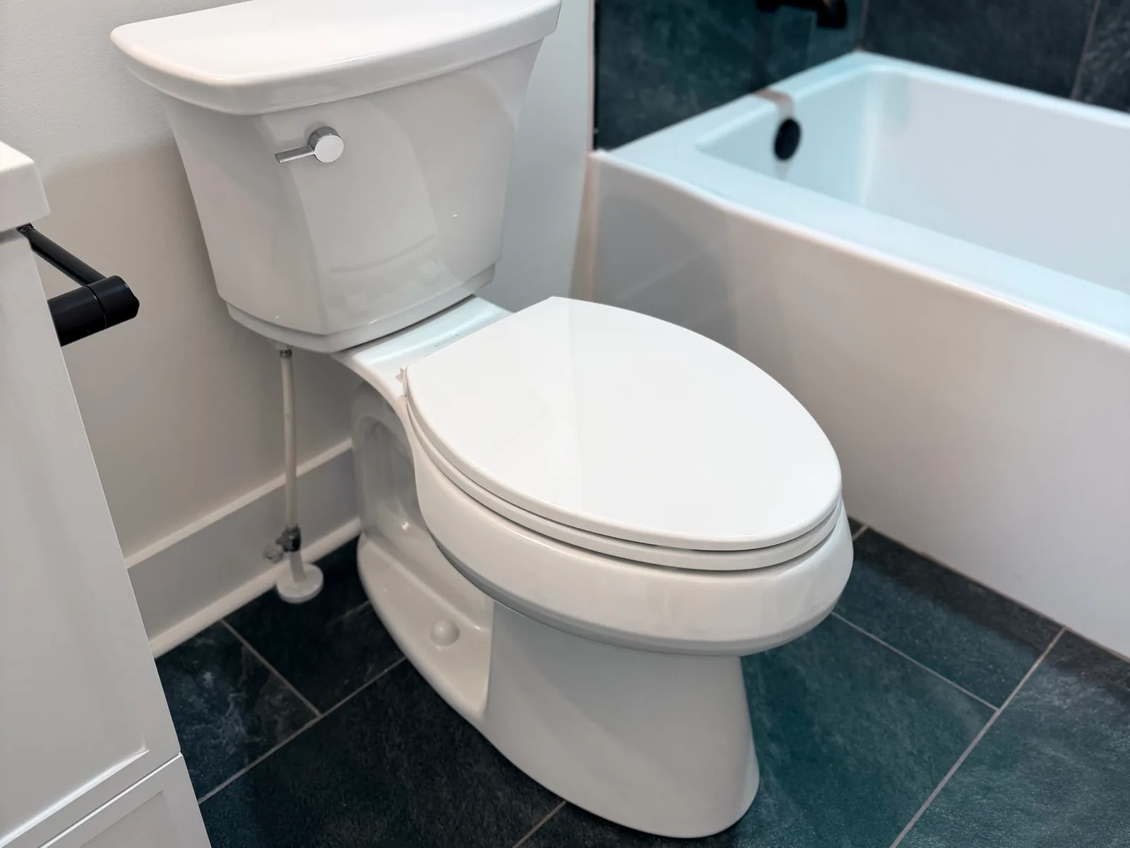 New toilet with a supply line beside a bathtub, toilet repair