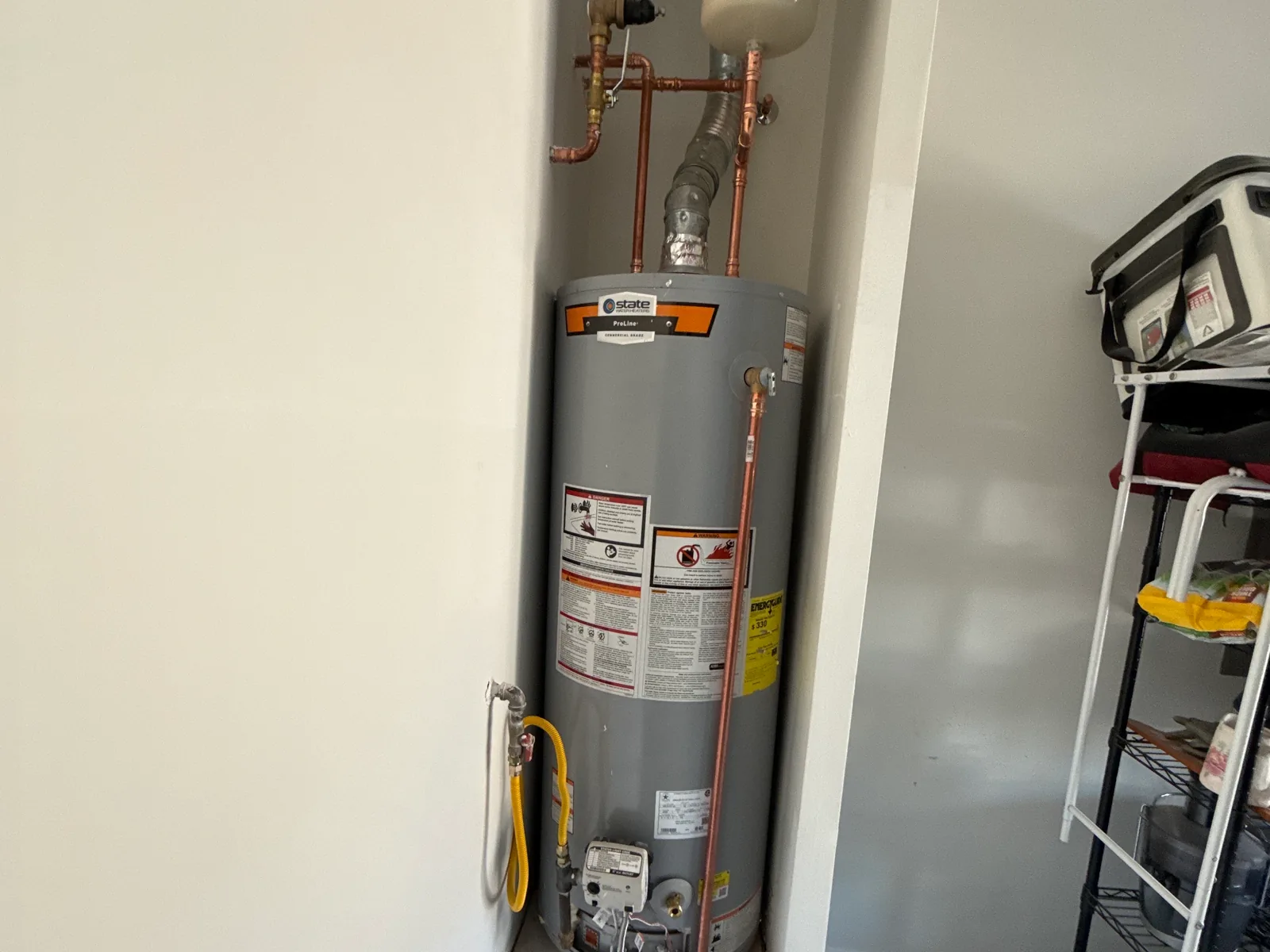 Gas water heater with an expansion tank installed in a closet, water heater installation