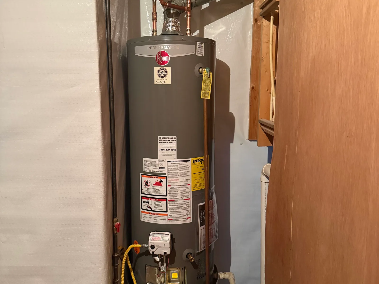 Gas tank water heater in a utility closet, water heater repair