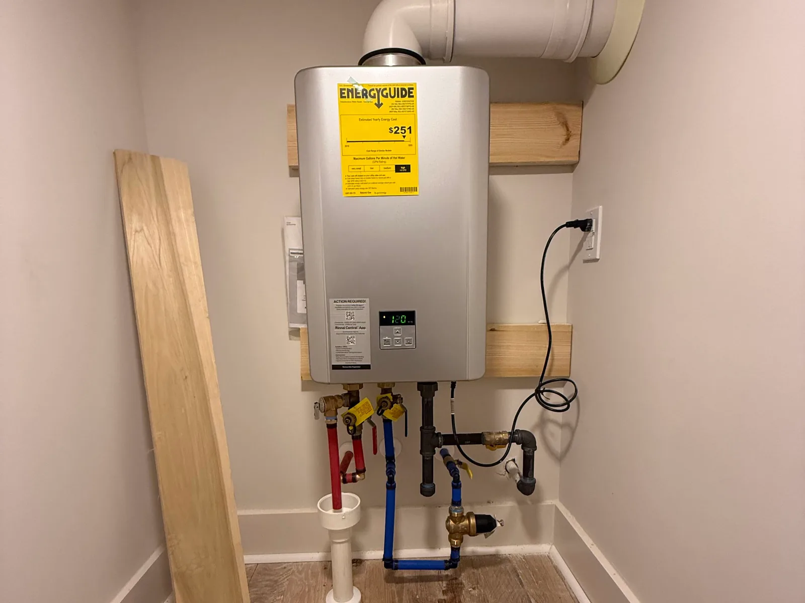 Tankless water heater with water and gas connections in a utility room, water heater repair