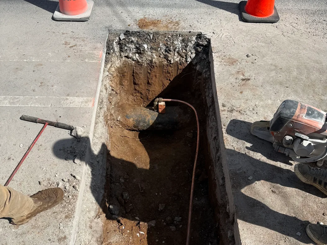 Copper water service line tapped into a water main in a street trench, water line repair